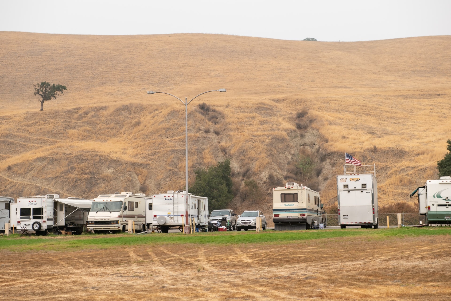 Row of recreational vehicles parked together at Bolado Park, San Benito County