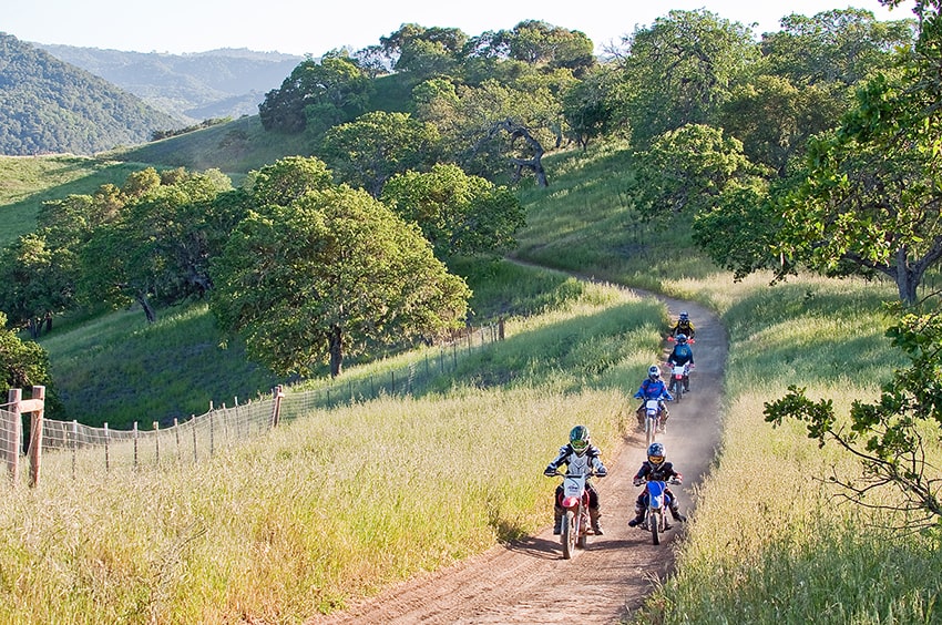 Dirt bike riders on a trail at Hollister Hills SVRA